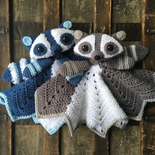 Two crocheted lovey raccoons